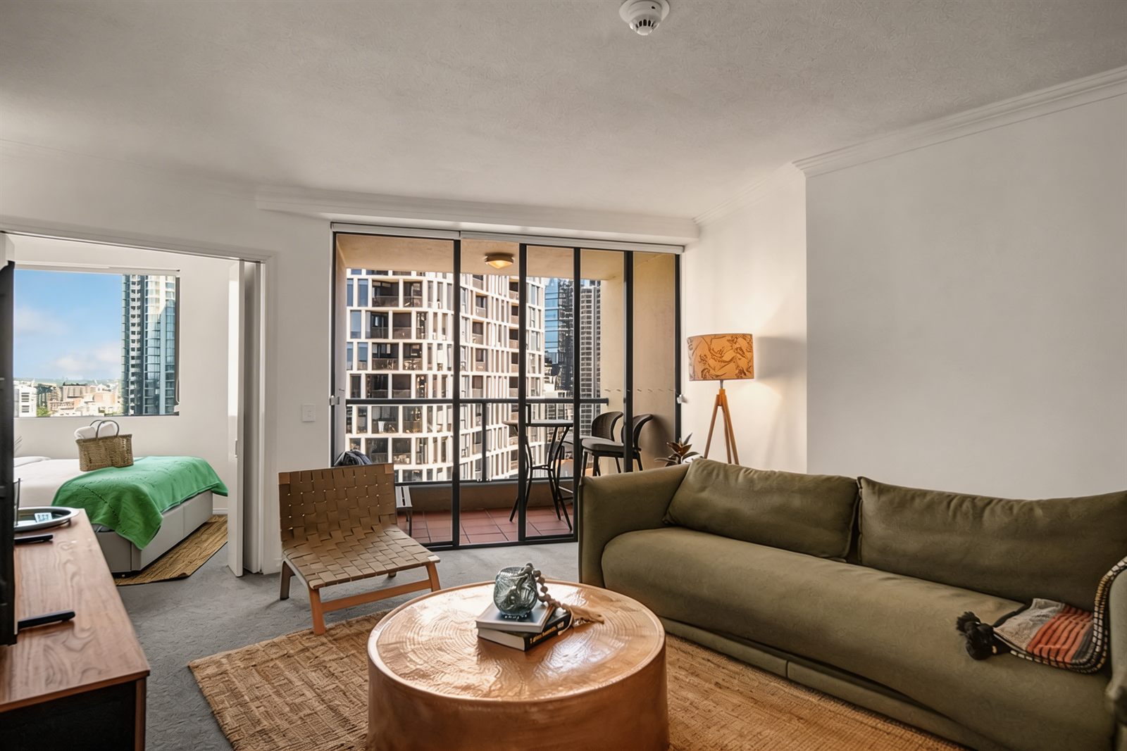 Living area, balcony and bedroom at Mantra 2201